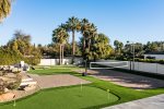 Amenity packed backyard with volleyball, putting green, corn hole & more